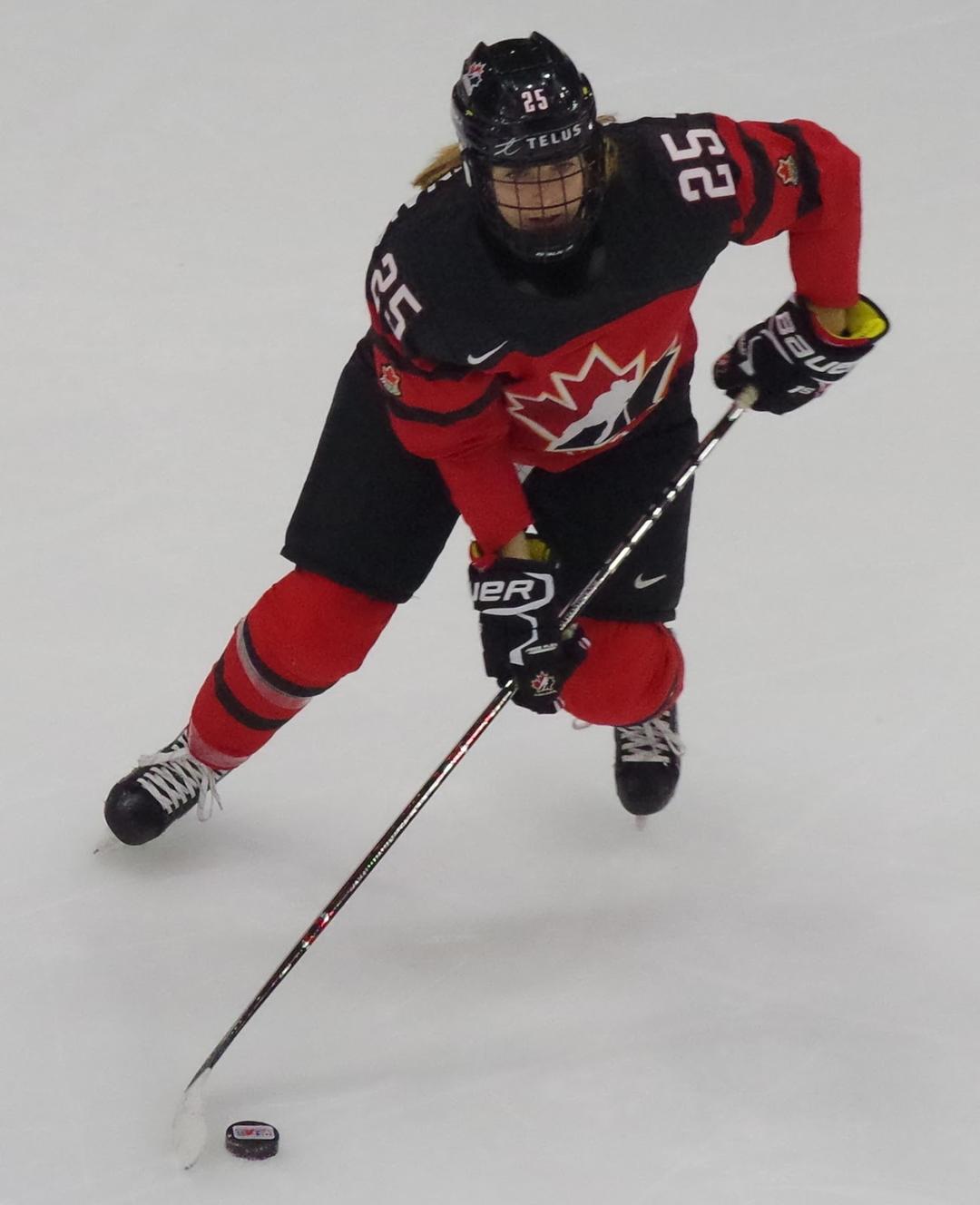 Quartexx Management client Jaime Bourbonnais skating with the puck for Team Canada