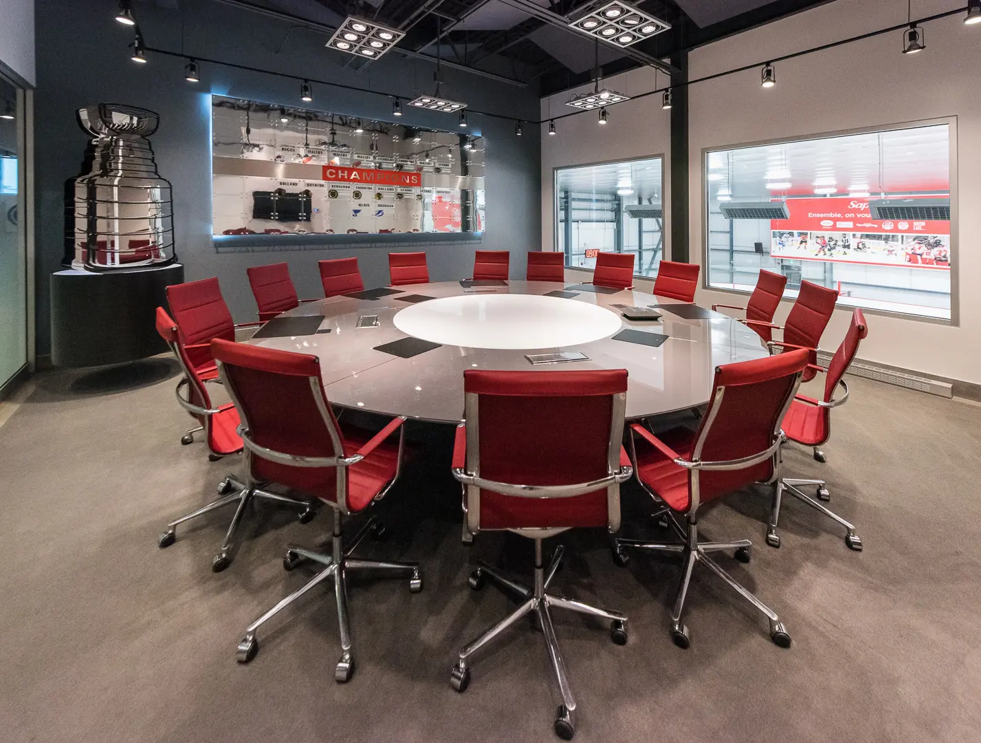 Quartexx Management boardroom with a large circular table and red office chairs