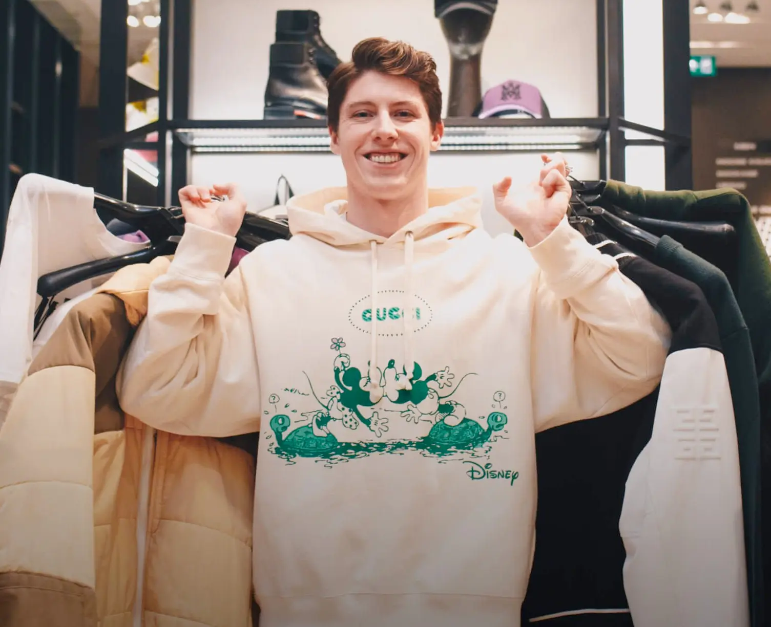 Mitch Marner holding a bunch of clothes and smiling on the show 'What do you wear?'