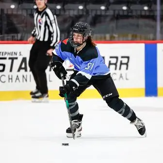 Victoria Bach carrying the puck in her PWHL Toronto jersey