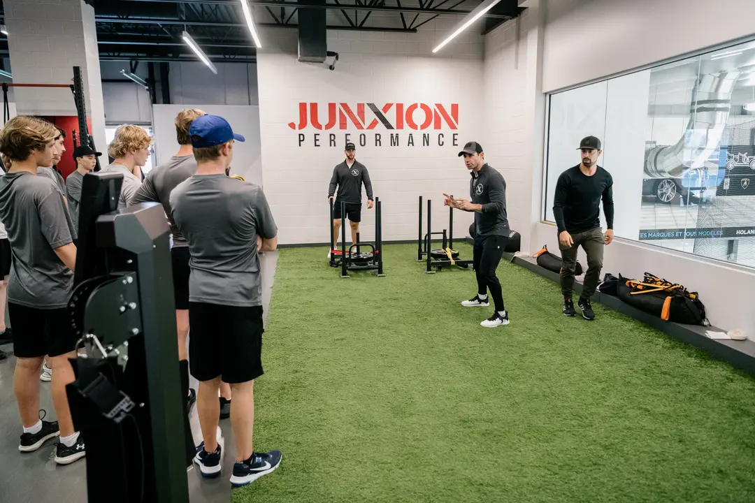 Andy O'Brien explaining a workout to a group of teenagers at Junxion Performance gym