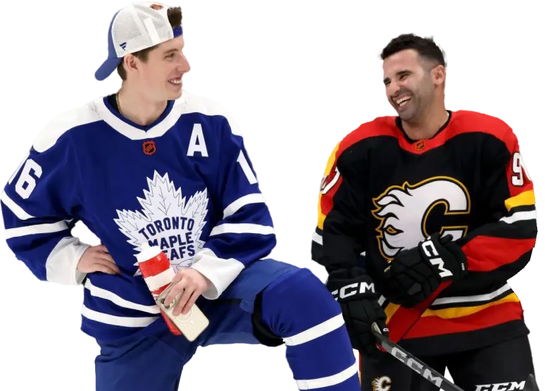 Mitch Marner and Nazem Kadri kneeling and laughing together at the 2023 NHL all-star game.