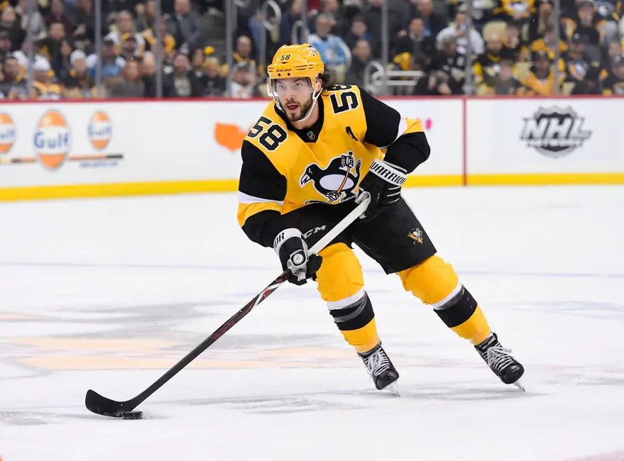 NHL athlete Kris Letang playing hockey for the Pittsburgh Penguins